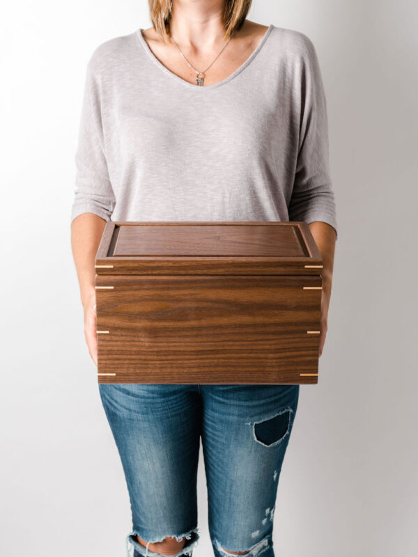 walnut keepsake box held in hands for scale
