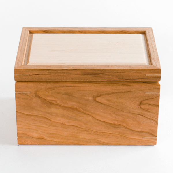 Cherry keepsake box with miter joinery and a hard maple lid, with a white background
