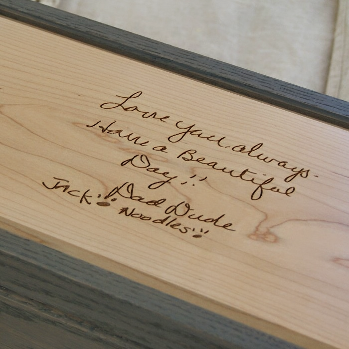 Inside lid of a keepsake box engraved with a heartfelt handwritten note reading “Love you always. Have a beautiful day!! — Dad Dude & Noodles,” capturing a personal message in the original handwriting.