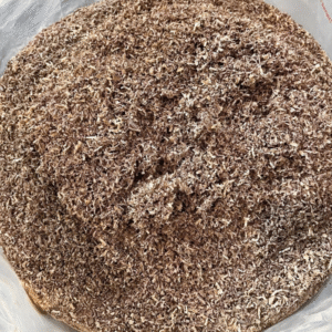 Close-up view of fine mixed hardwood sawdust showing texture and color variations from walnut, cherry, hard maple, and oak.