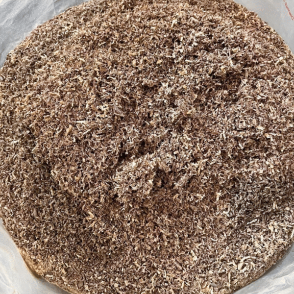 Close-up view of fine mixed hardwood sawdust showing texture and color variations from walnut, cherry, hard maple, and oak.