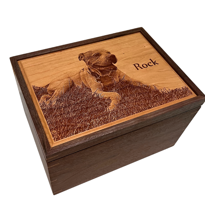 Laser-engraved portrait of a dog named "Rock" on the cherry lid of an extra-large walnut keepsake box; a pet memorial example from Mad Tree Woodcrafts.