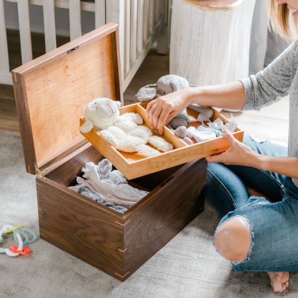 Walnut and cherry keepsake box with removable tray holding baby keepsakes