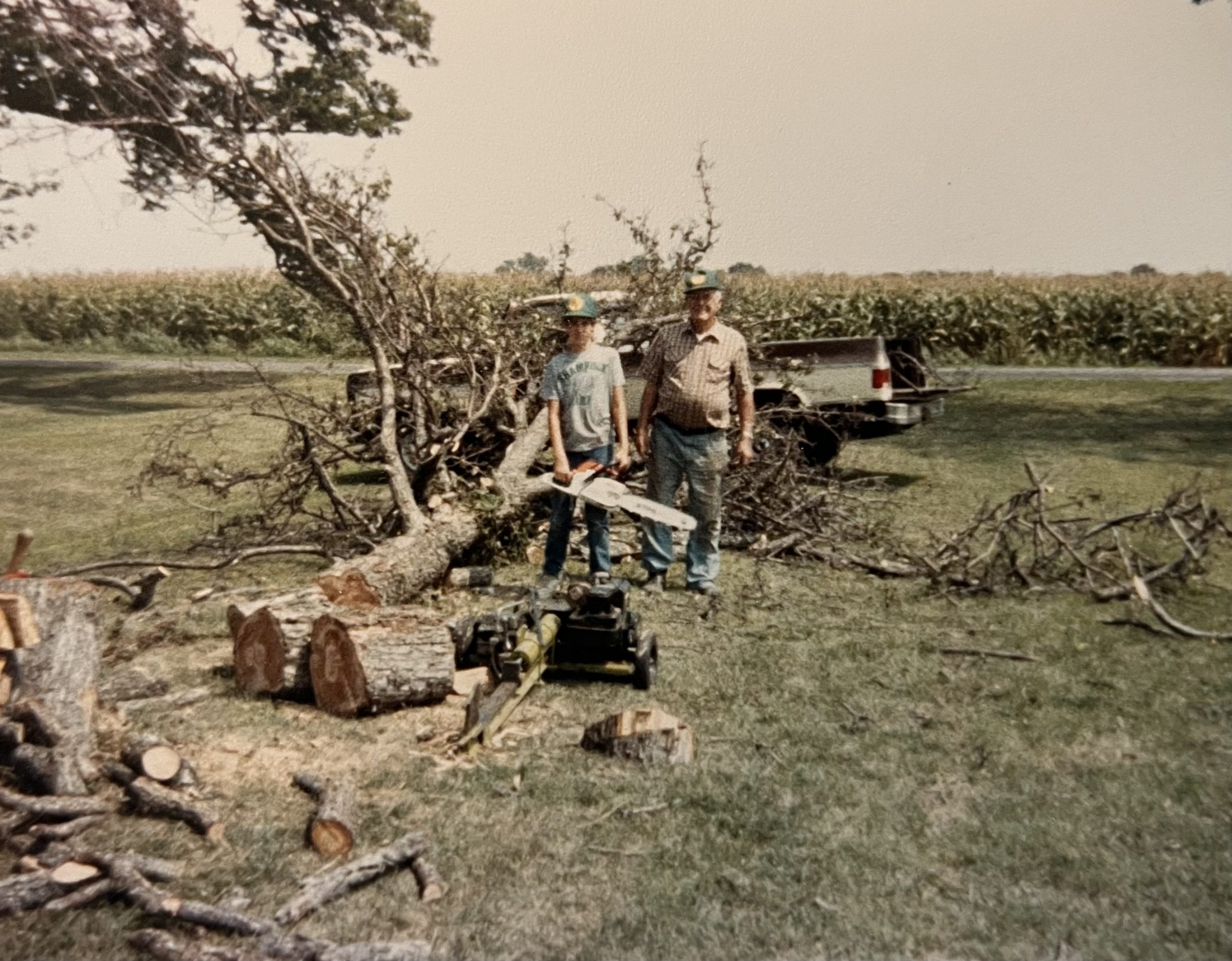 Young Tyler Bishop Hall cutting wood alongside his grandfather Leland Bishop on the family farm.