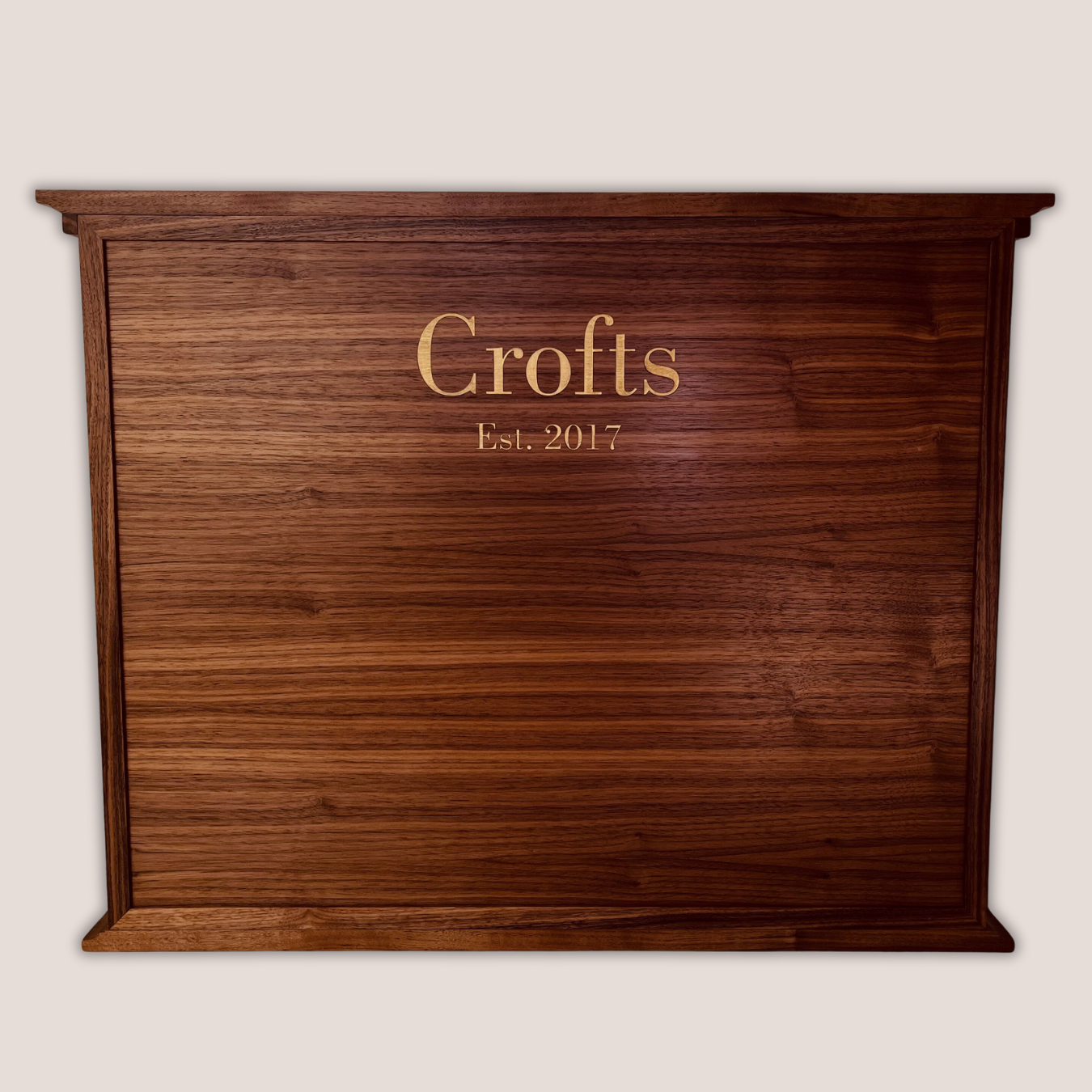 Back of a handcrafted walnut advent calendar featuring custom family name engraving and year