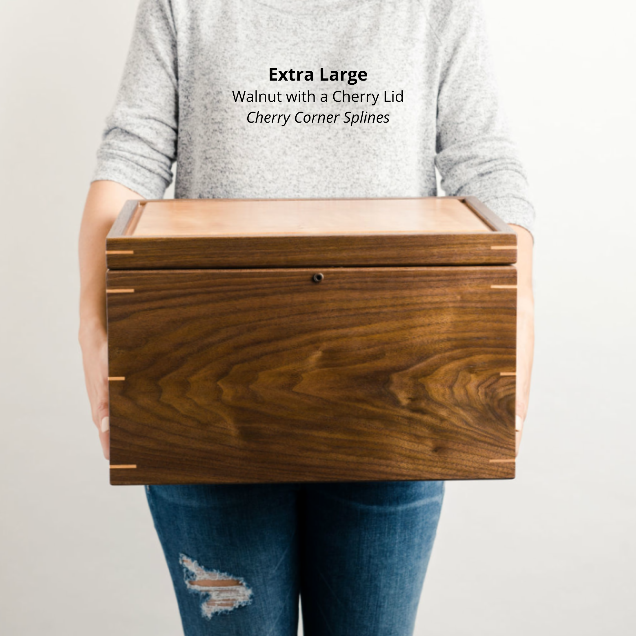 Woman holding an extra large walnut keepsake box with a cherry lid and cherry corner splines, to show size and scale