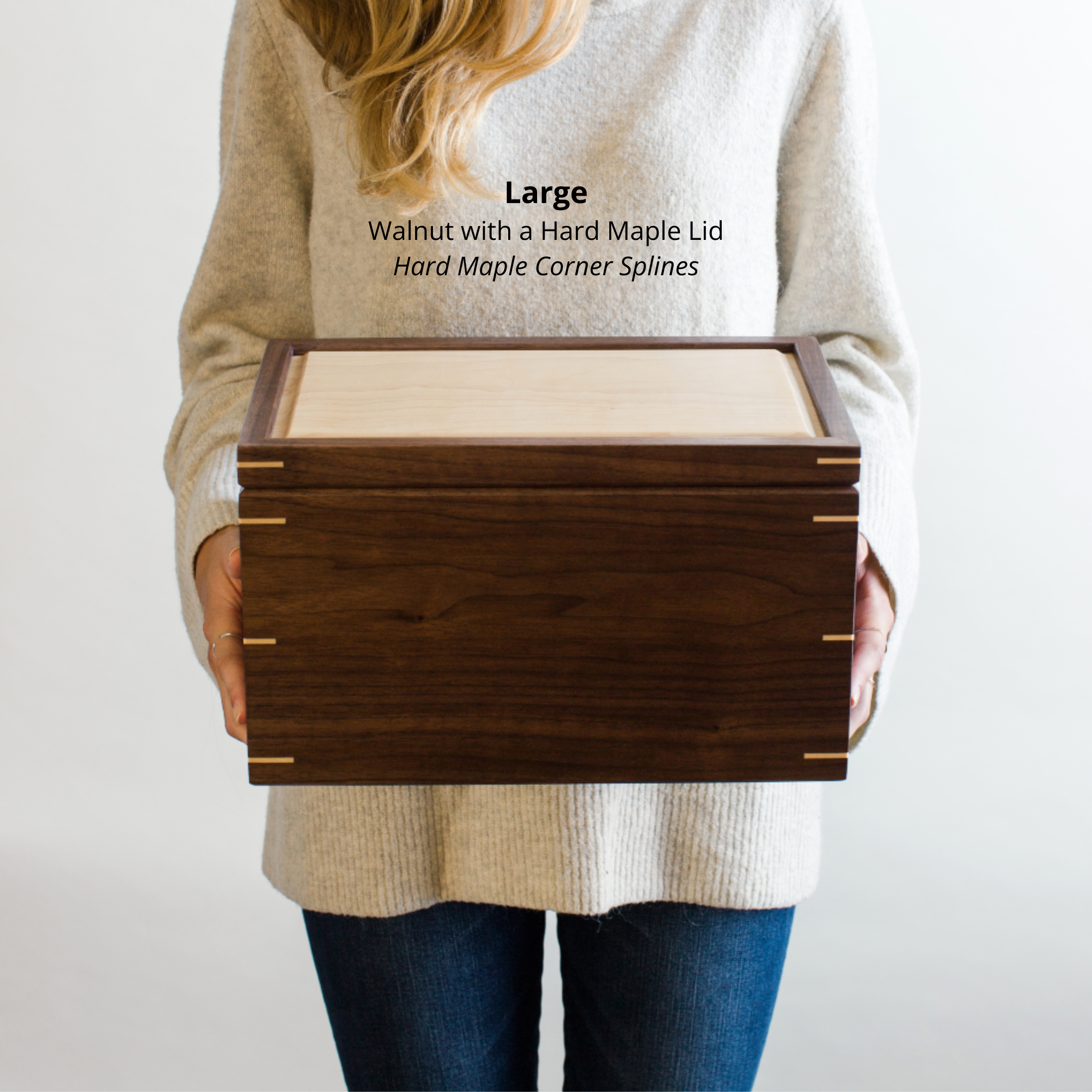 Woman holding a large walnut keepsake box with a hard maple lid and maple corner splines, to show size and scale