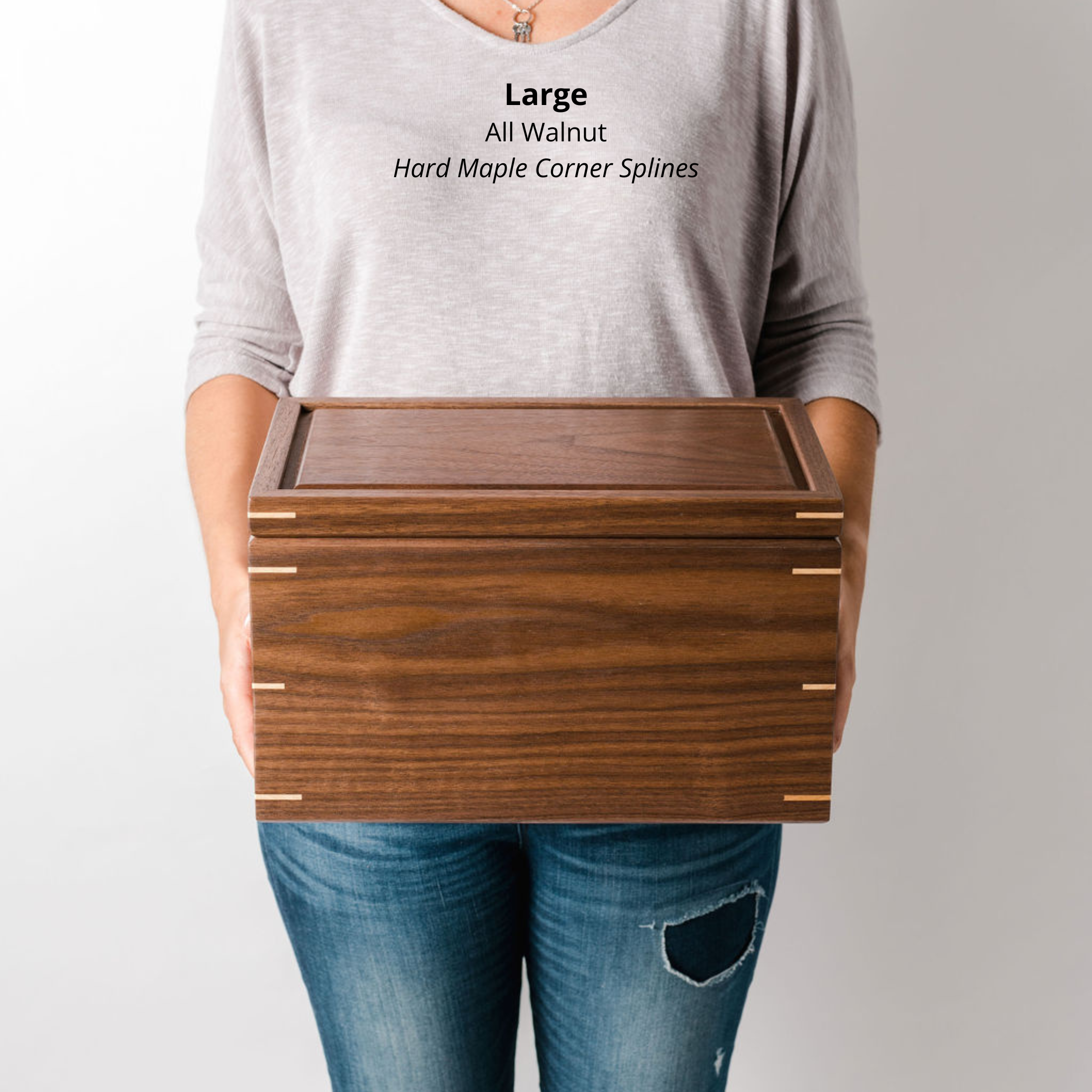 Woman holding a large walnut keepsake box with a walnut lid and maple corner splines, to show size and scale