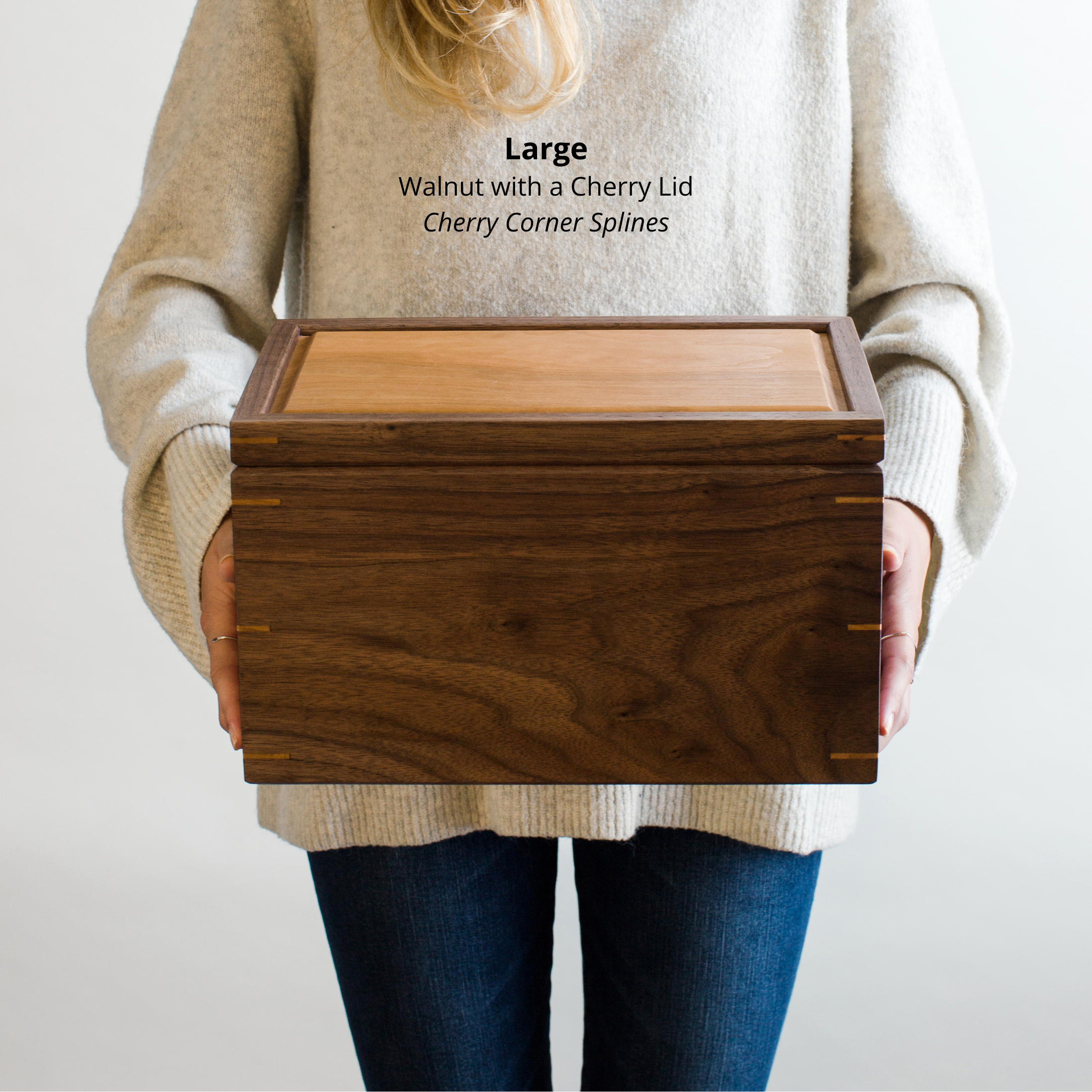 Woman holding a large walnut keepsake box with a cherry lid and cherry corner splines, to show size and scale
